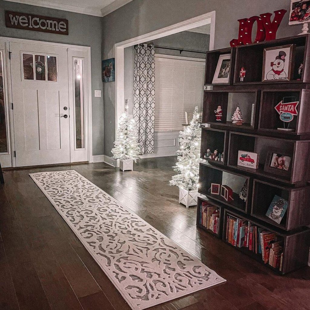 Cozy Lit Entryway with White Christmas Trees