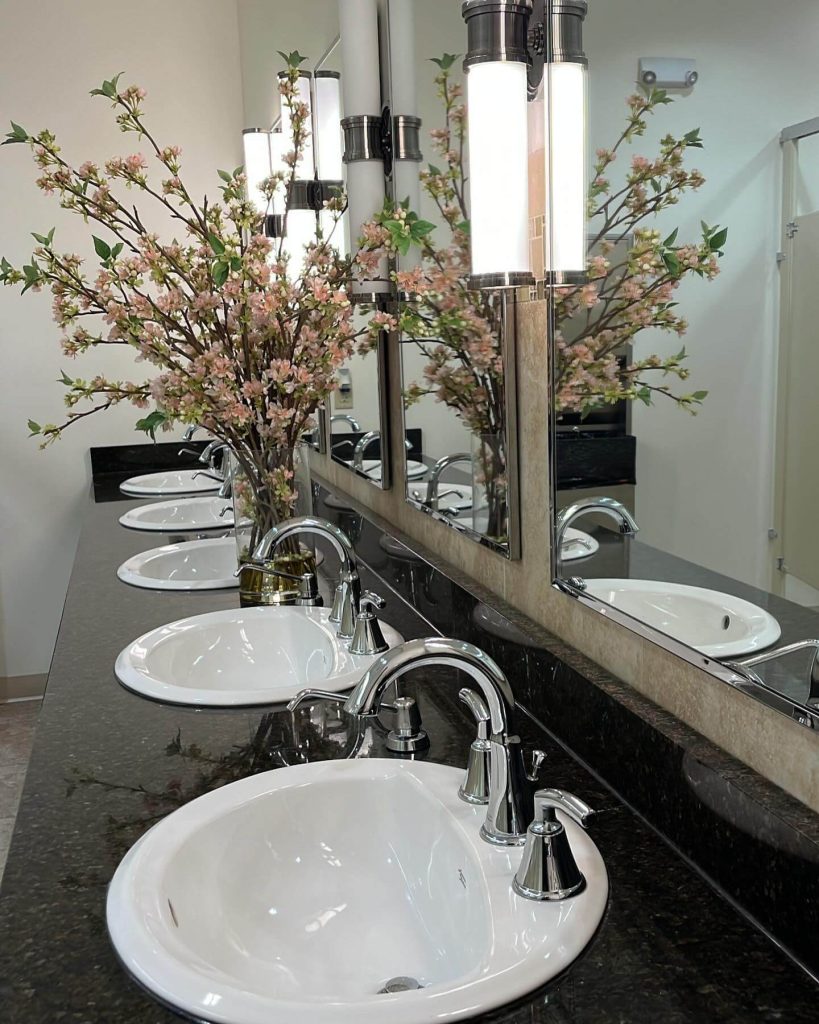 Elegant Vanity with Floral Touches and Modern Lighting