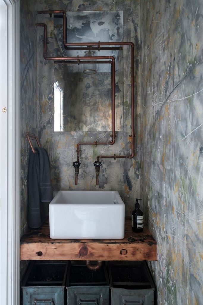 Exposed Copper Piping in Industrial Bathroom