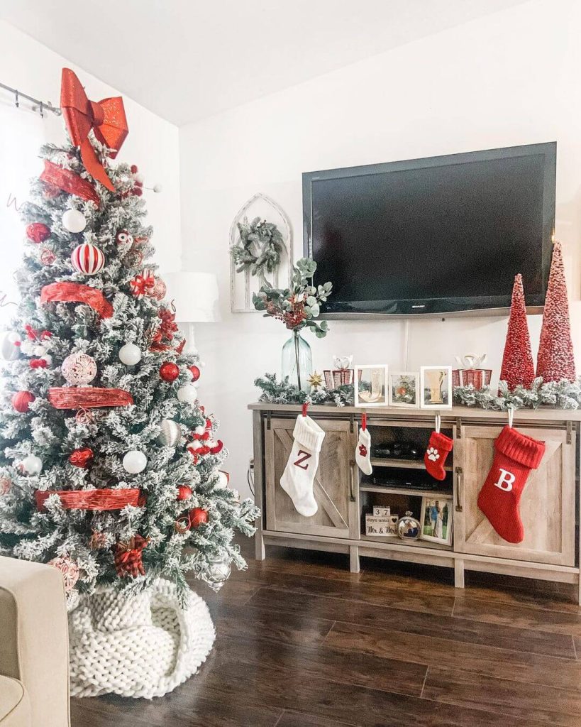 Flocked Tree and Red Accents for a Festive TV Stand