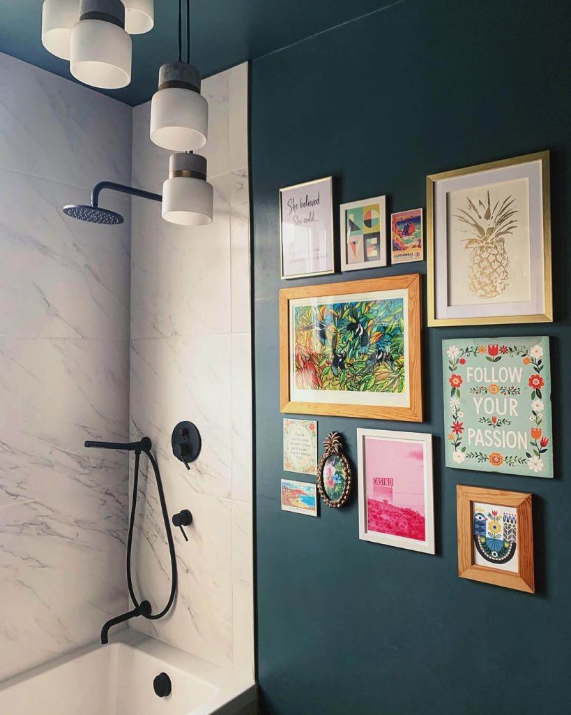 Gallery Wall Above Bathtub with Eclectic Art Pieces