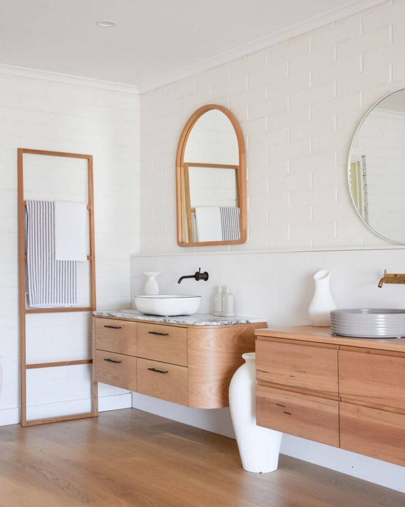 Light Wood Vanity with Dual Mirrors and Arched Design