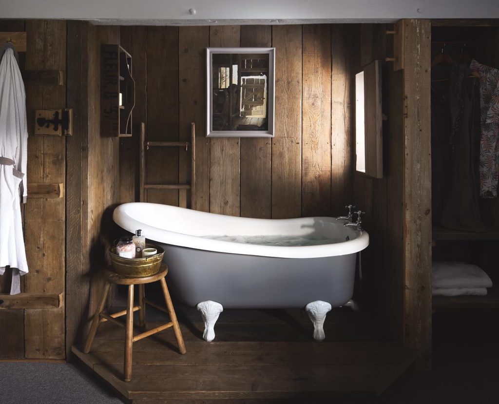 Minimalist Rustic Bathroom with a Clawfoot Tub