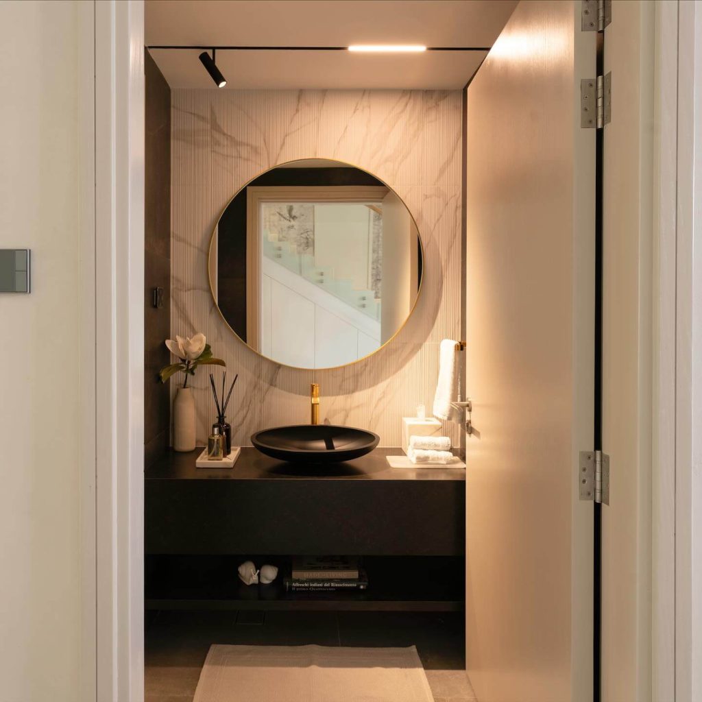 Modern Powder Room with Dramatic Lighting