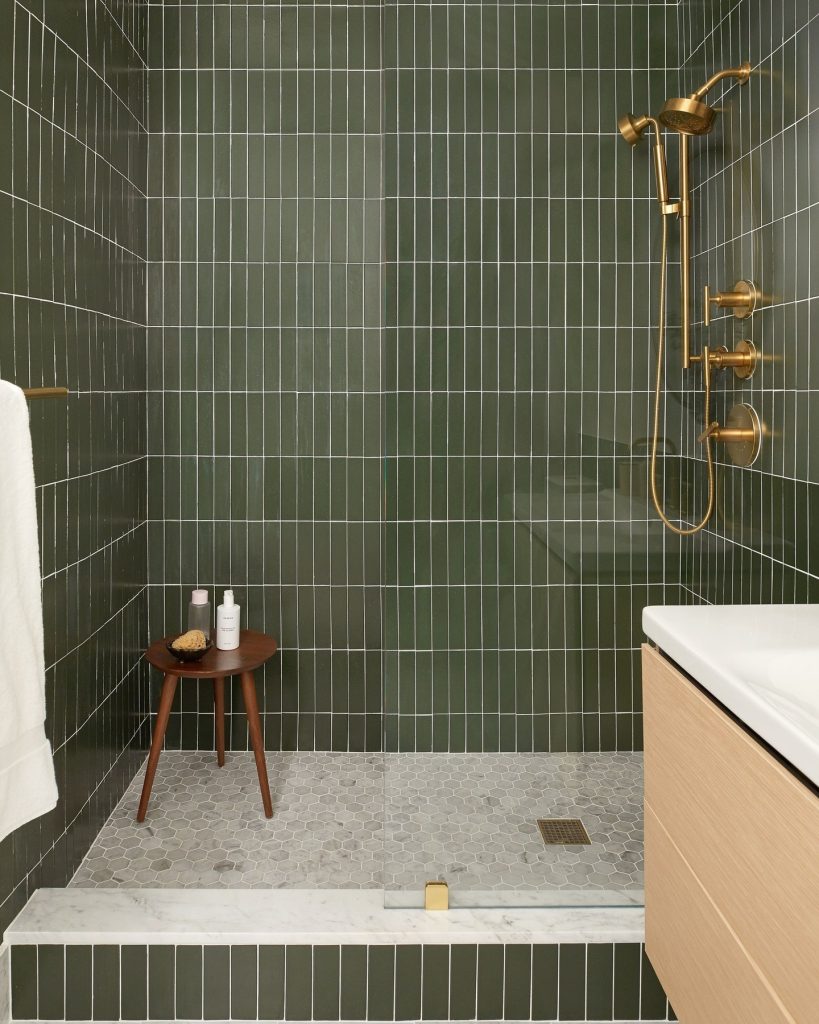 Streamlined Vertical Green Tiles with Brass Accents