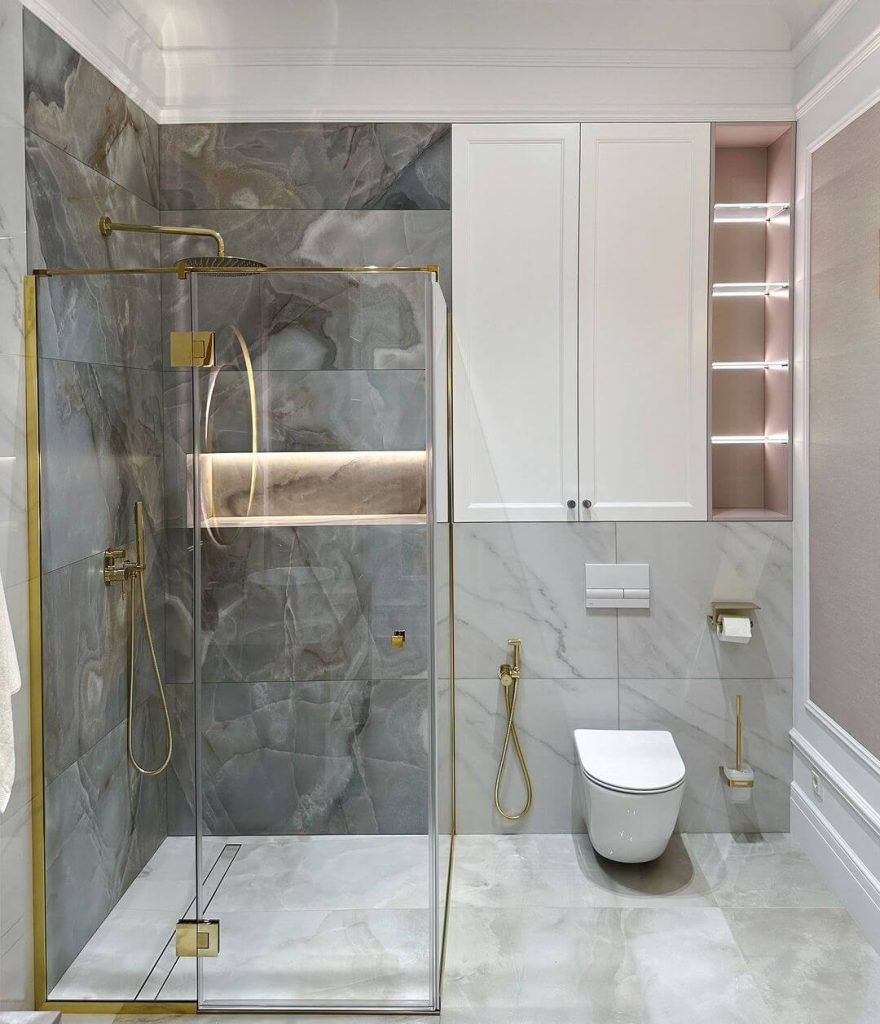 Elegant Master Bathroom with Brass Accents and Marble Shower