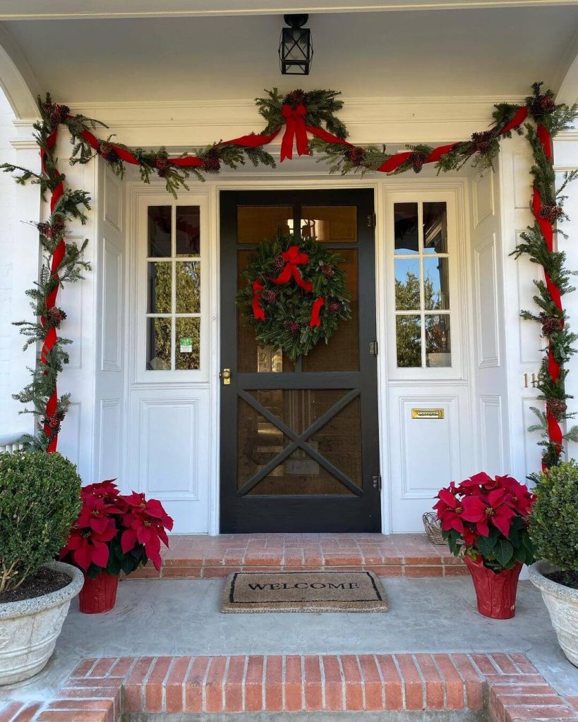 Festive Front Door with Red Ribbon Garland