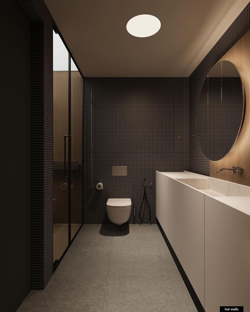 Minimalist Master Bathroom with Dark Tile and Circular Mirror