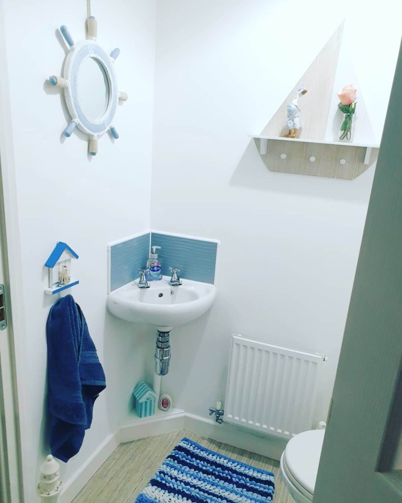 Playful Nautical Bathroom with Ship Wheel Mirror