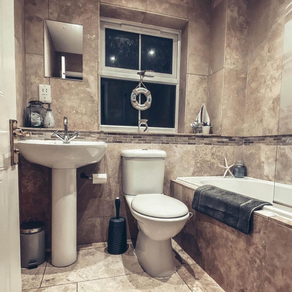 Rustic Nautical Bathroom with Sand-Toned Tiles