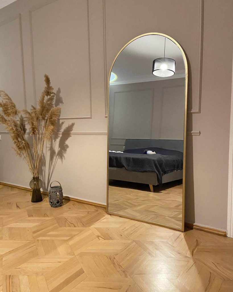 18. Elevate Sophistication with a Brass-Edged Mirror