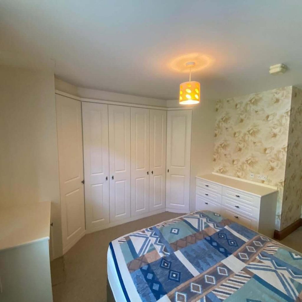27. Compact Corner Wardrobe for Space Optimization