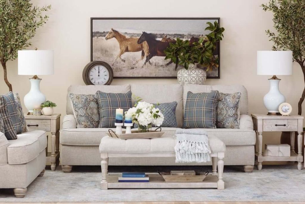 15. Anchor a Farmhouse Living Room with Rustic Wall Art