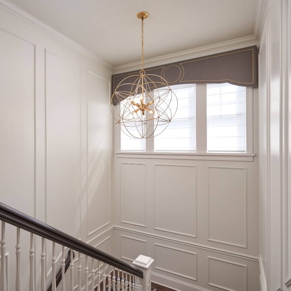 8. Go Classic with Elegant Wainscoting and Sculptural Lighting