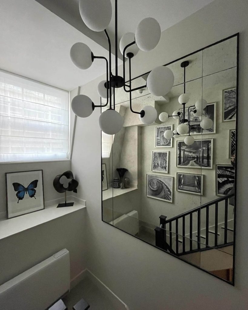9. Double the Impact with Mirrors and Monochrome Art