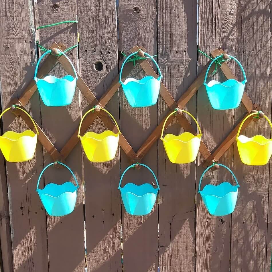 11. Colorful Hanging Buckets for a Playful Vertical Garden