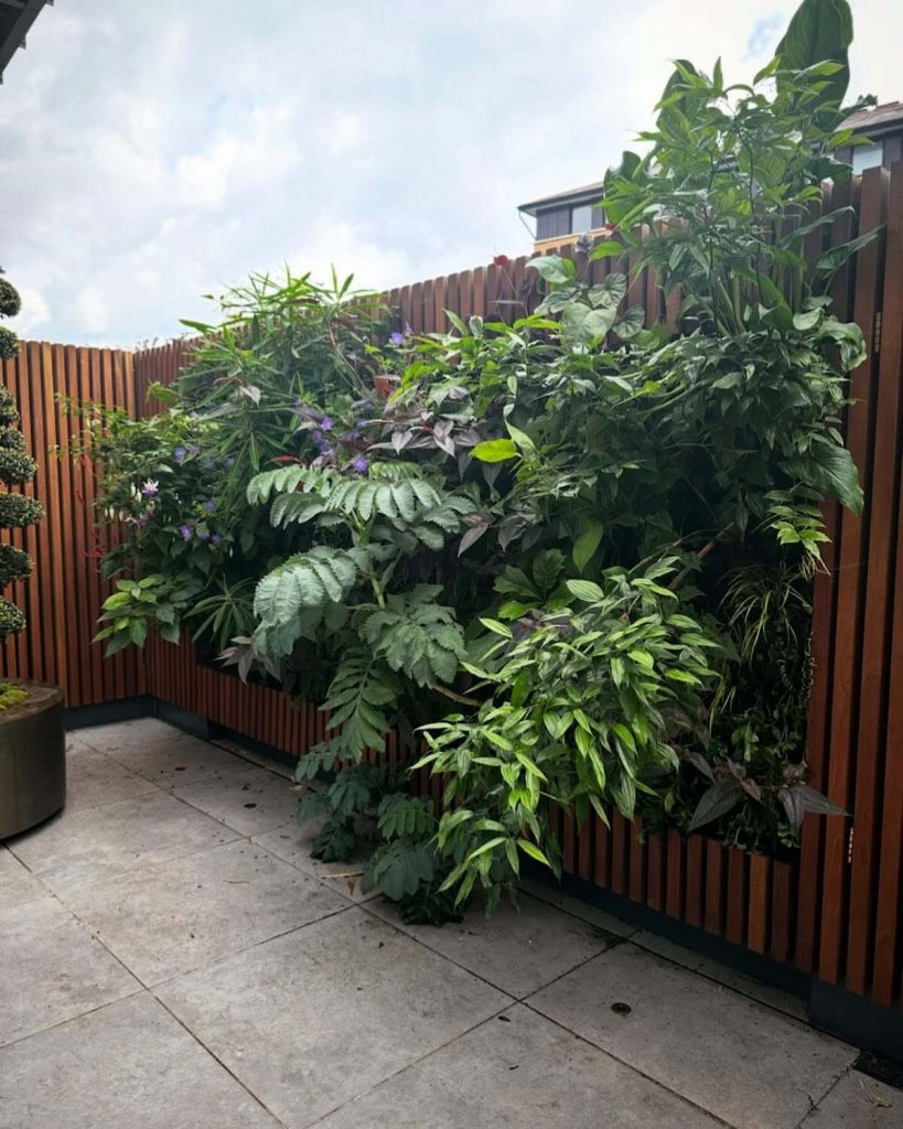 13. Corner Privacy Garden Wall with Dense Greenery