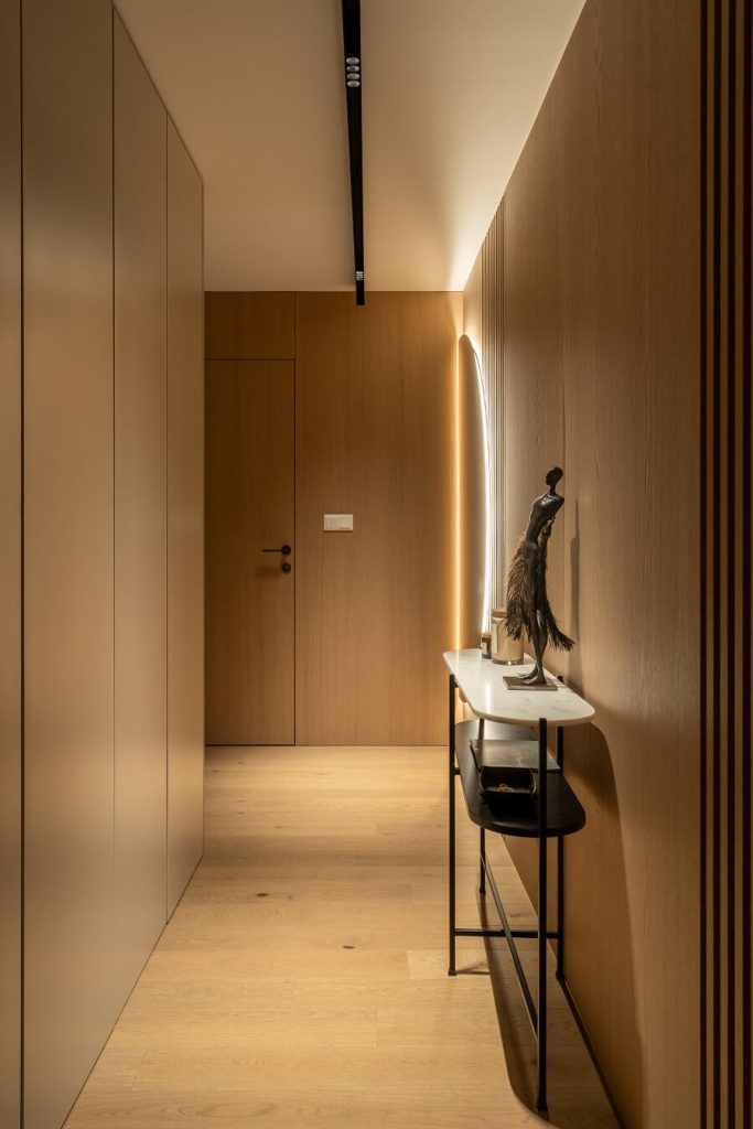 14. Seamless Wood Veneer Paneling for Minimalist Halls