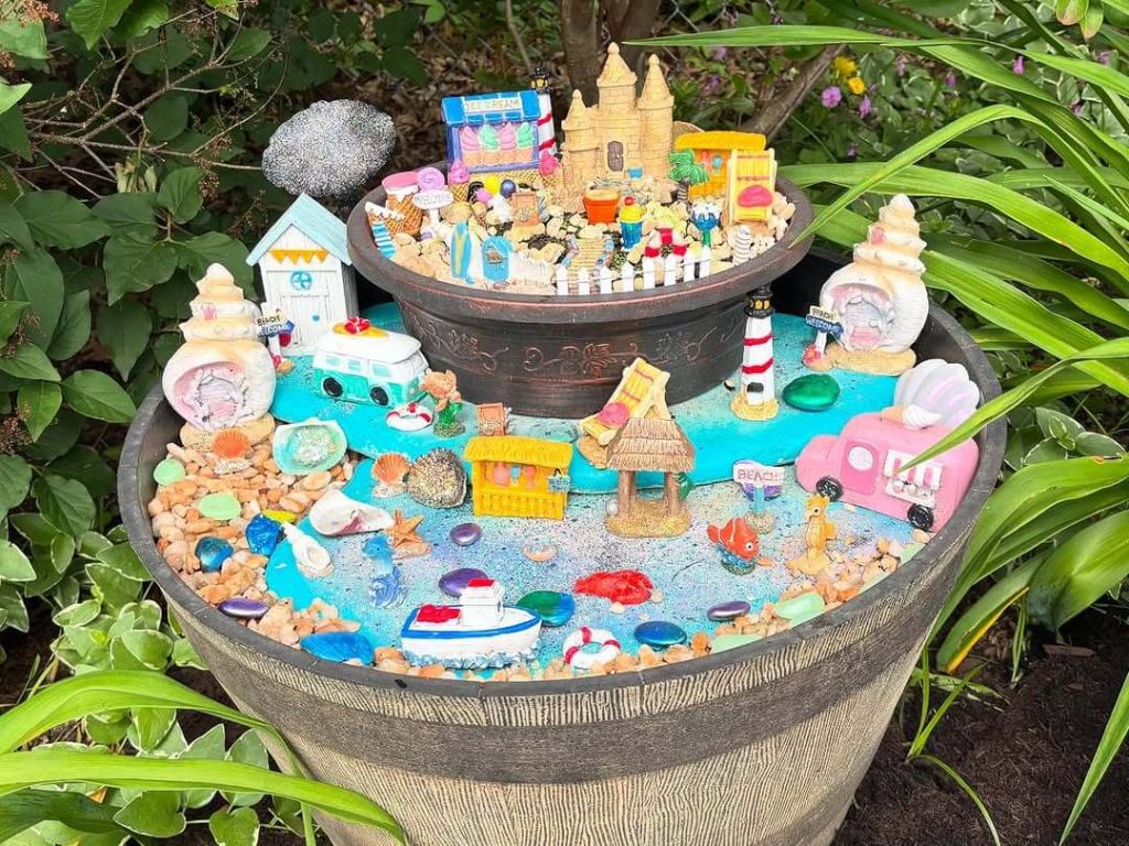 18. Beach-Themed Fairy Garden in a Tiered Barrel