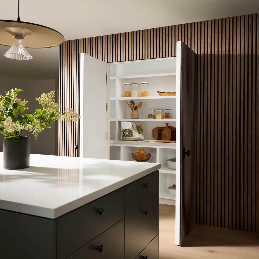 20. Hidden Pantry Behind Seamless Wood Paneling