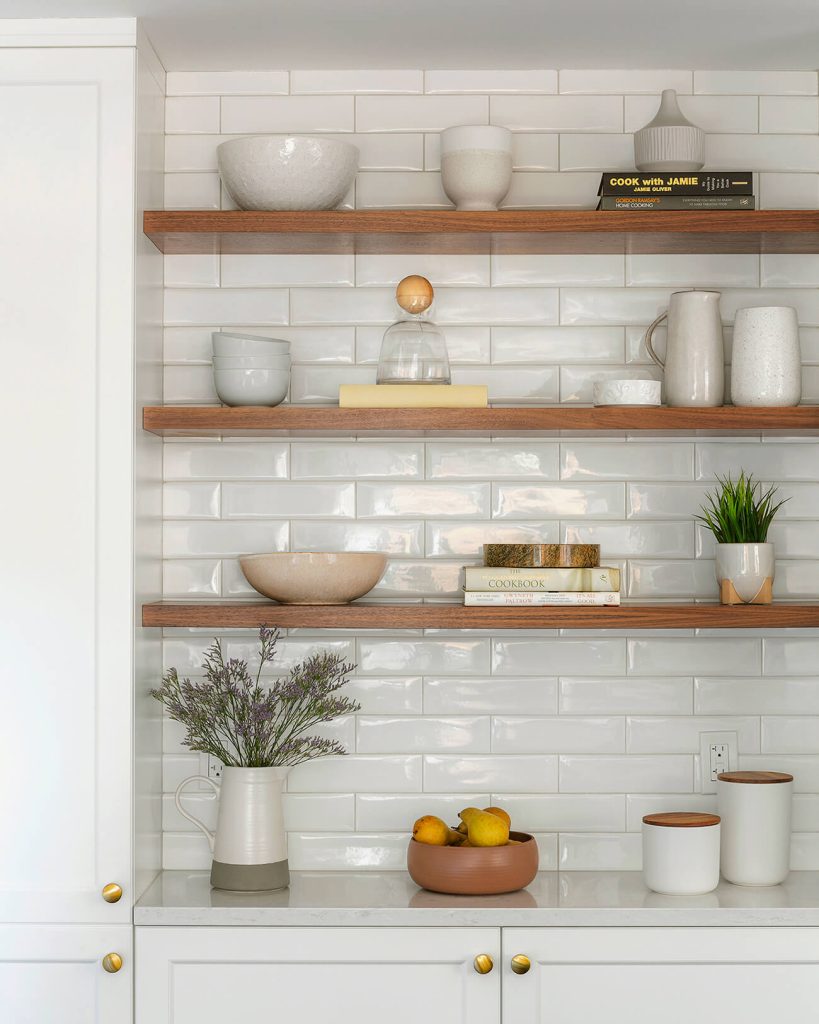 27. Glossy Tile Backdrop With Natural Wood Shelving