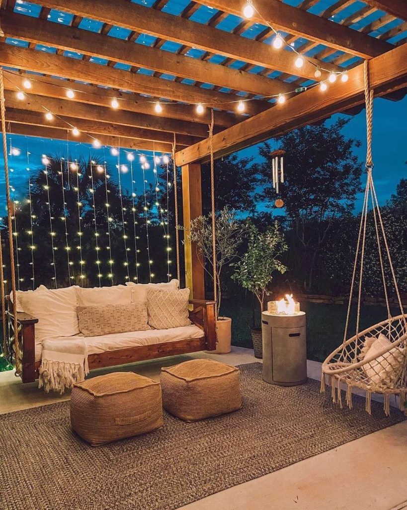 3. Cozy Up Under a Pergola with Hanging Seating and Firelight