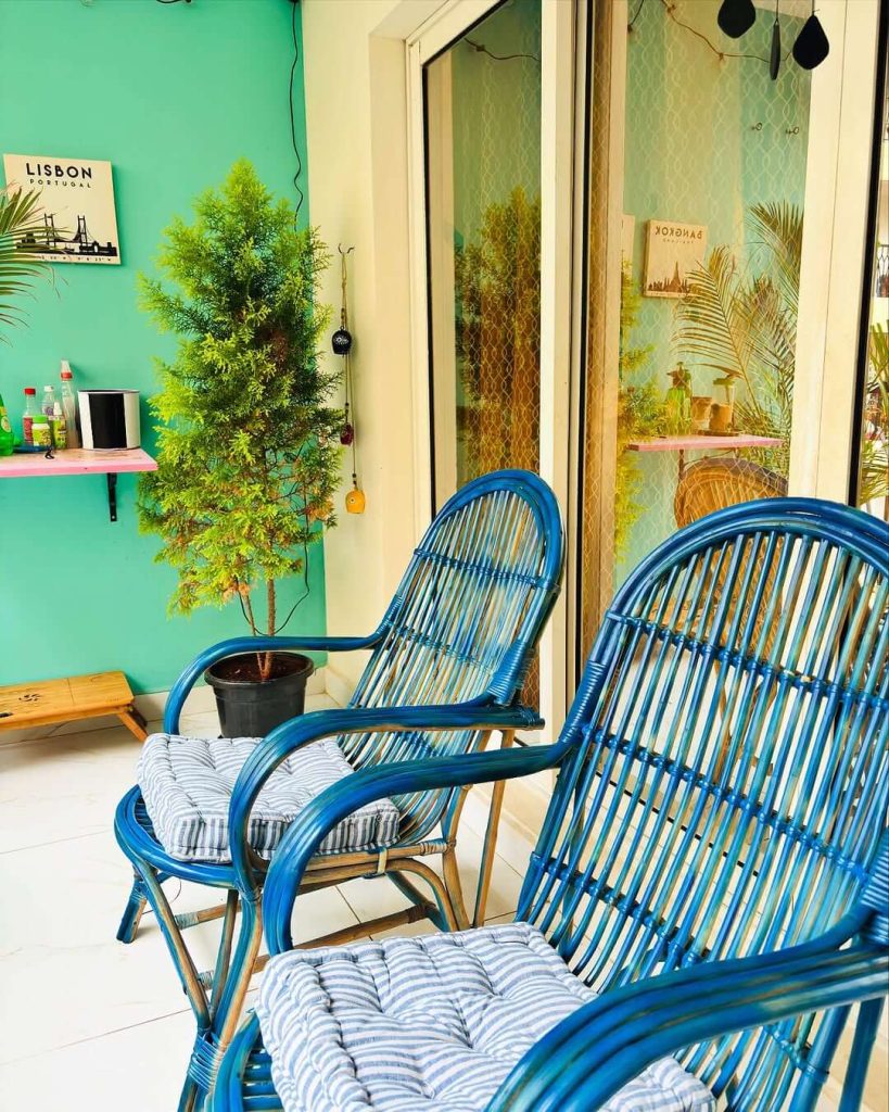 6. Tropical Teal Balcony with Bold Rattan Accents