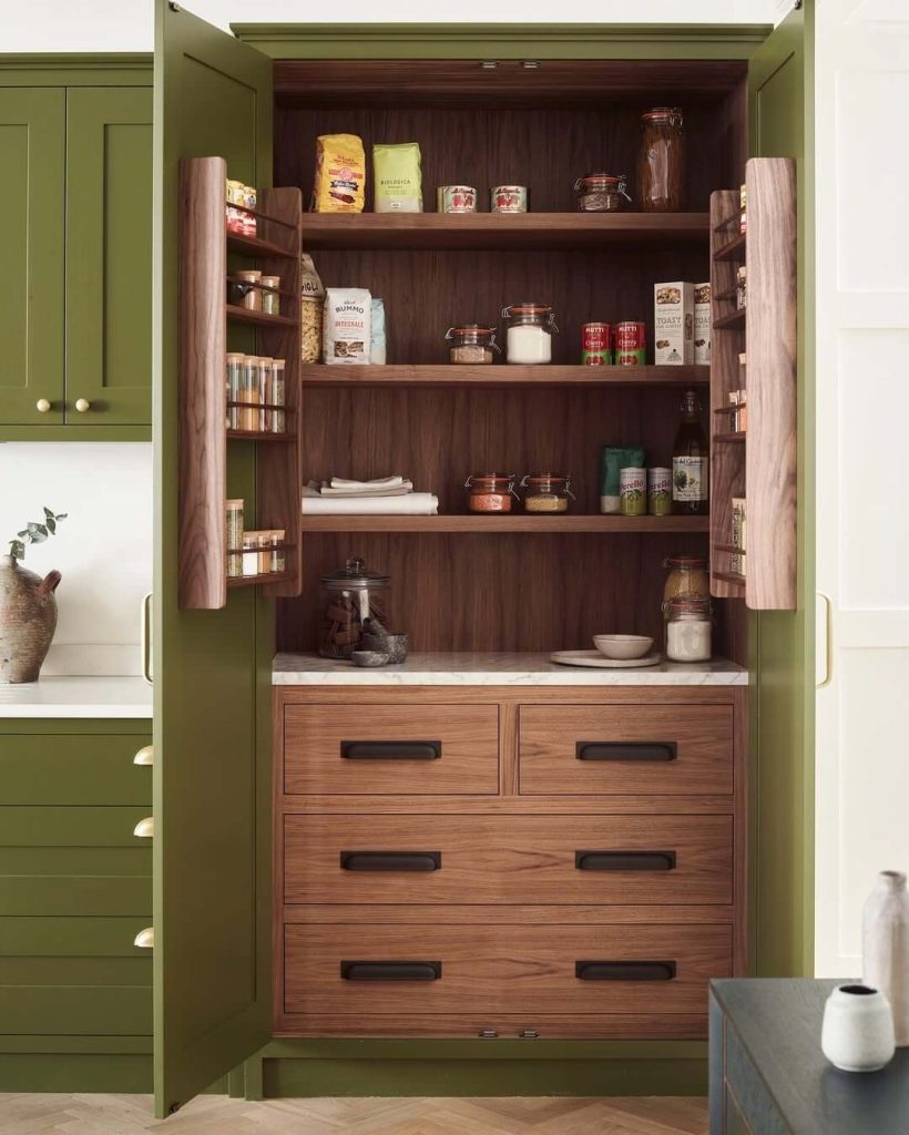 10. Earthy Green Pantry with Warm Walnut Accents