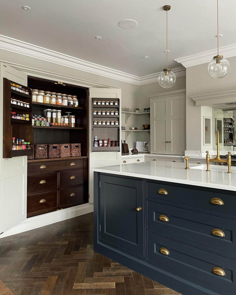 11. Elegant Pantry Cabinet with Dark Wood and Brass Accents