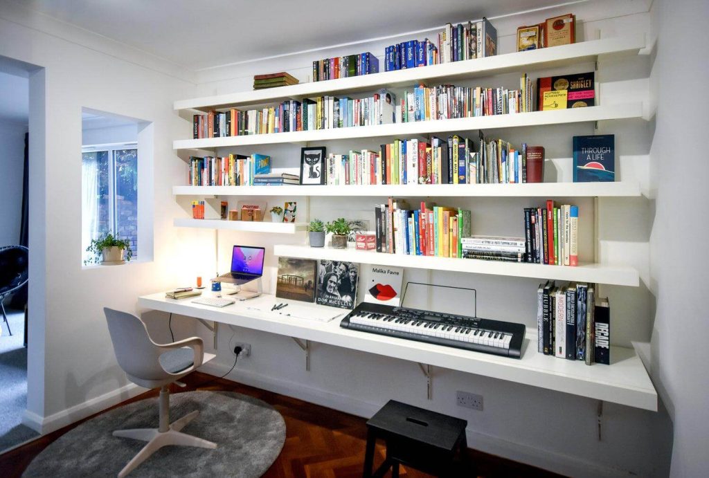 11. Dark Wood Shelving in a Dramatic Workspace