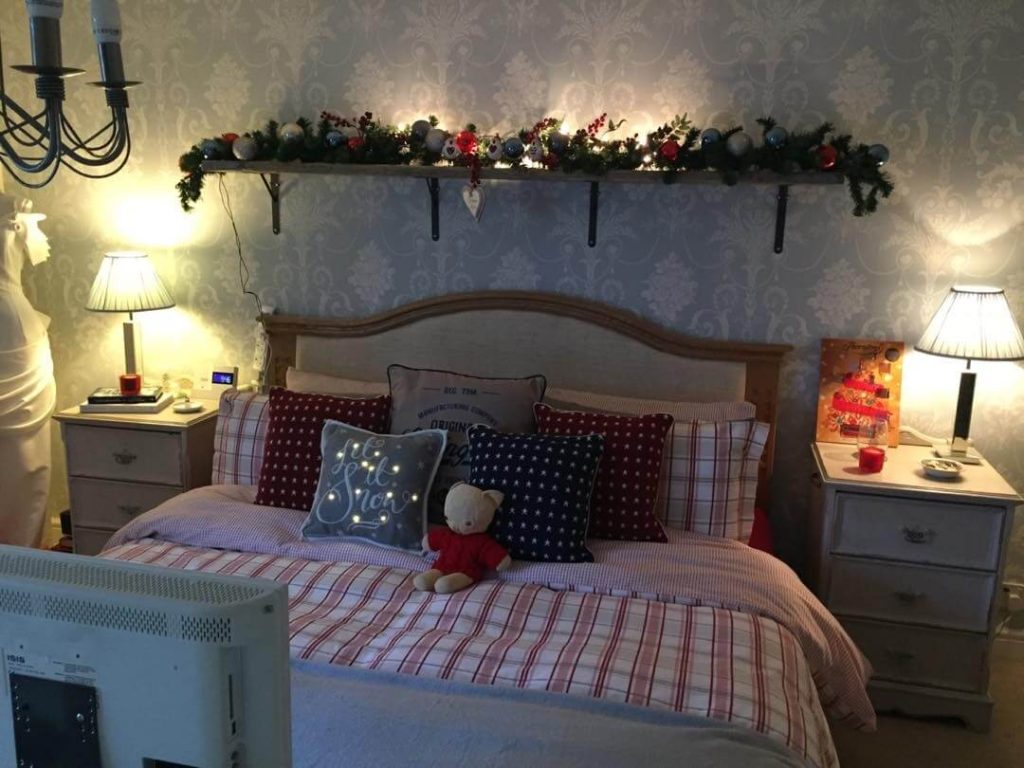 13. Festive Charm with a Holiday-Themed Shelf