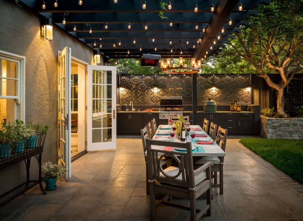 14. Al Fresco Dining Oasis with String Lights and Decor Accents