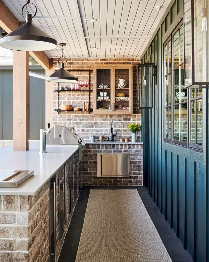 15. Cottage-Inspired Brick Kitchen with Indoor Touches