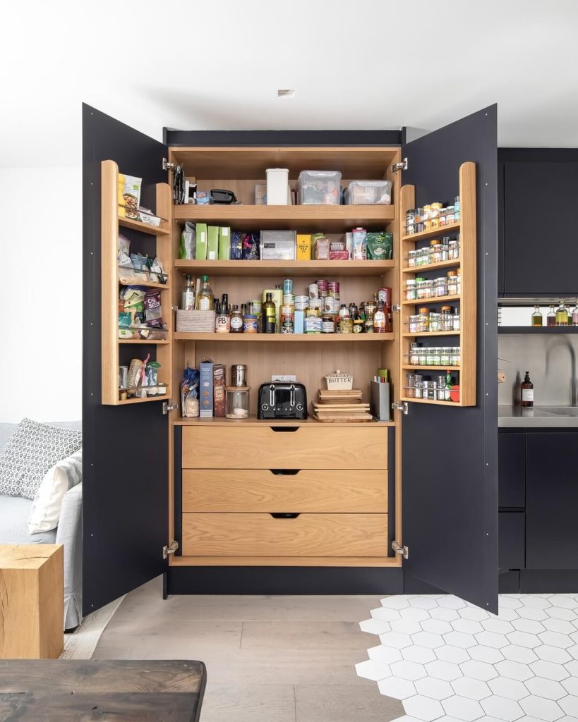 17. Bold Contrast Pantry with Matte Black and Wood