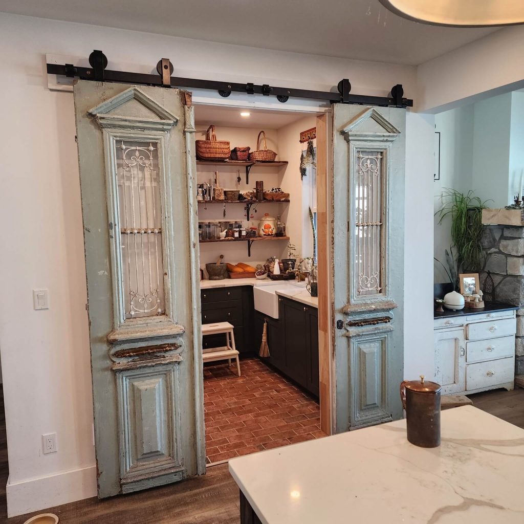 21. Charming Cottage Pantry with Vintage Sliding Doors