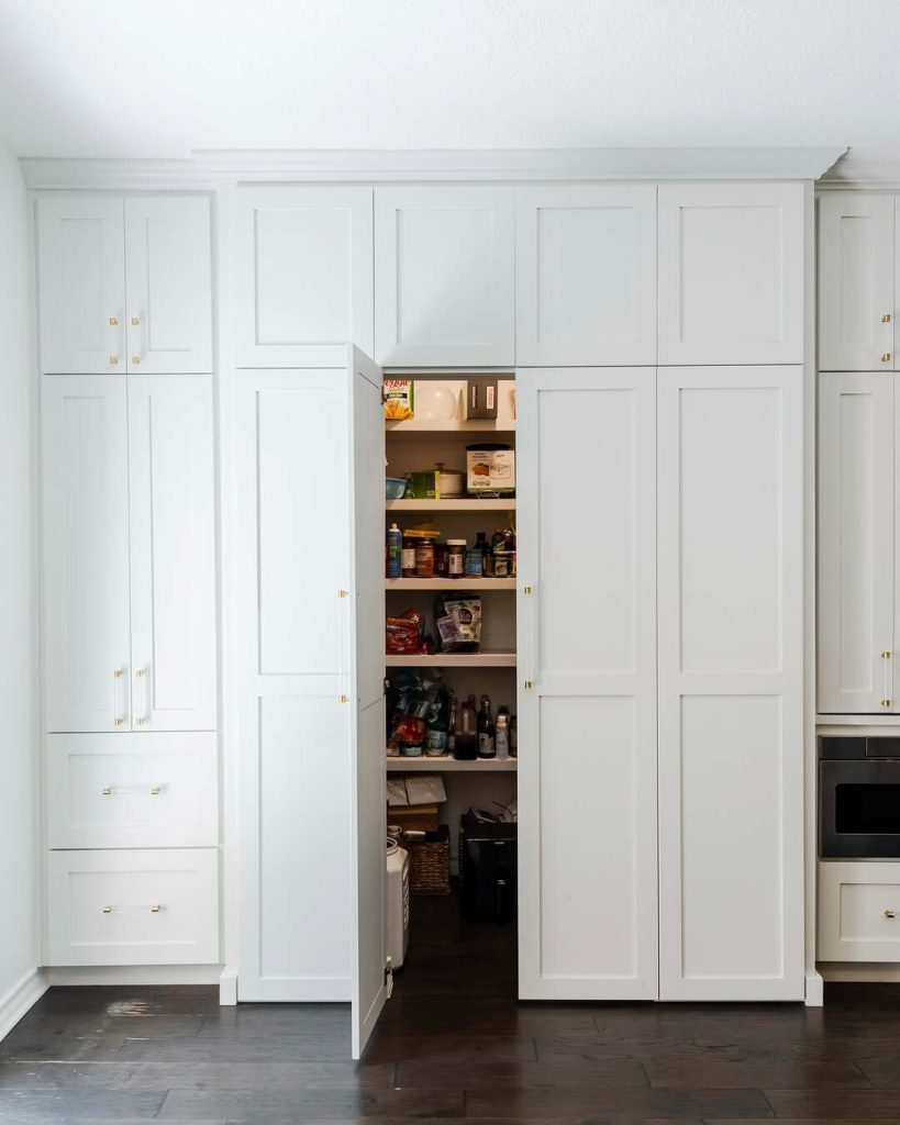 23. Hidden Pantry Behind Seamless Cabinet Doors