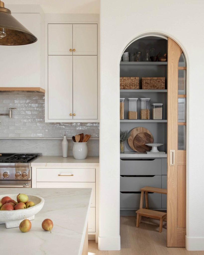 3. Hidden Pantry Nook with Arched Entry and Minimalist Style