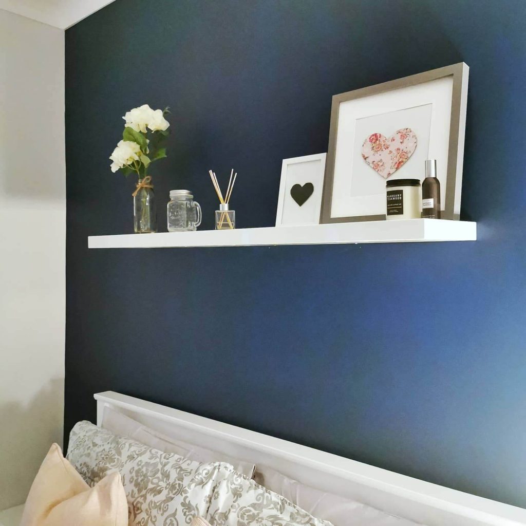 5. Simple Shelf Styling Against a Bold Accent Wall