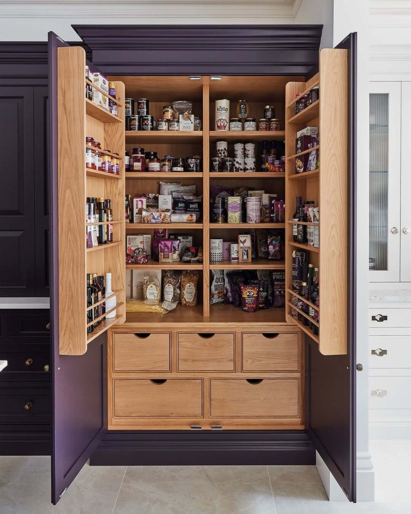 6. Elegant Pantry with Royal Hues and Ample Drawers